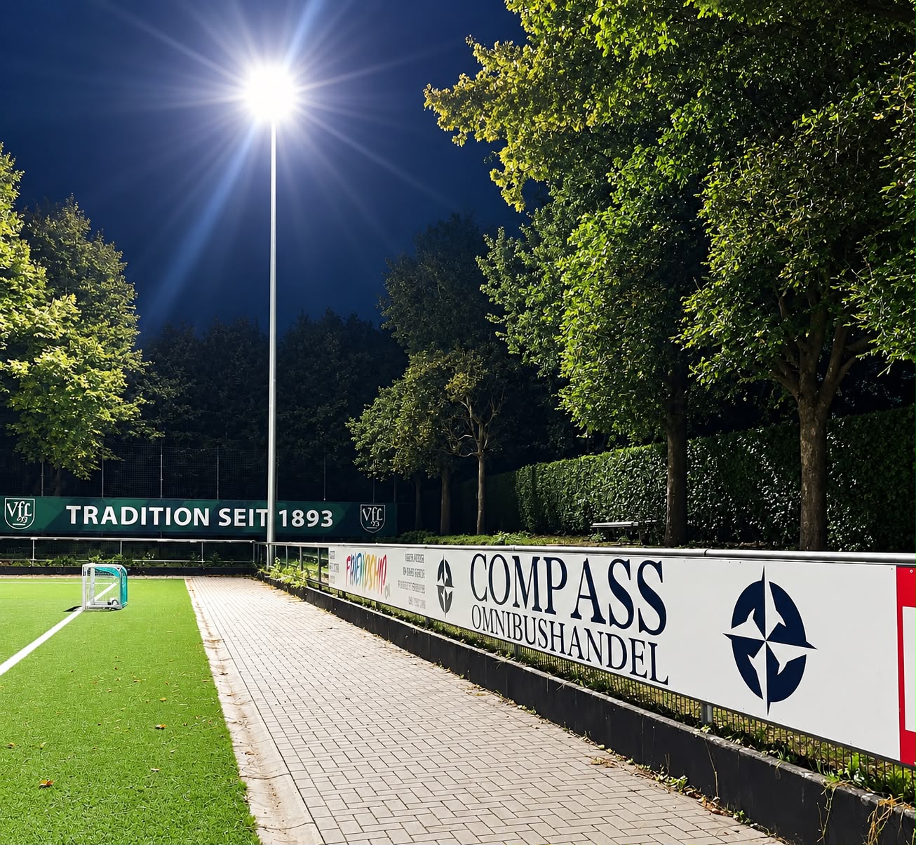Compass Omnibushandel advertising board at the VfL 93 Hamburg sports ground under floodlights