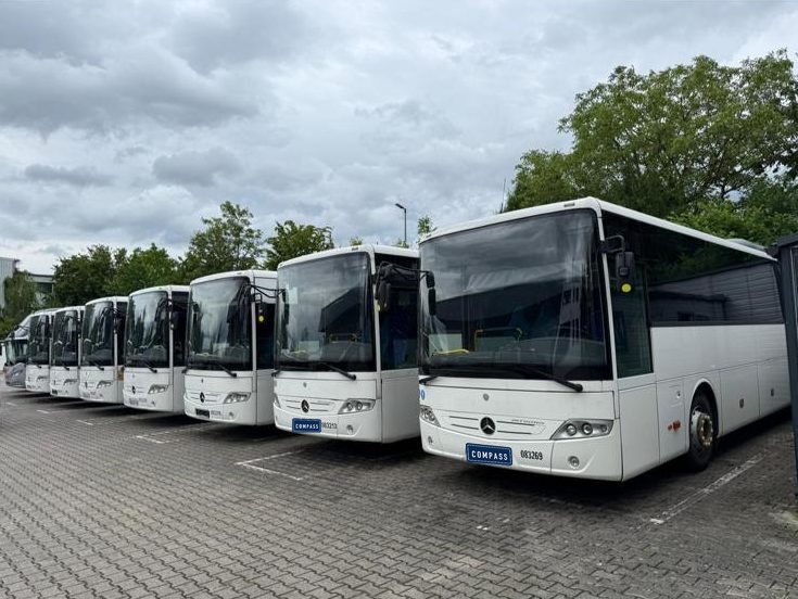 Row of white Mercedes-Benz Intouro coaches