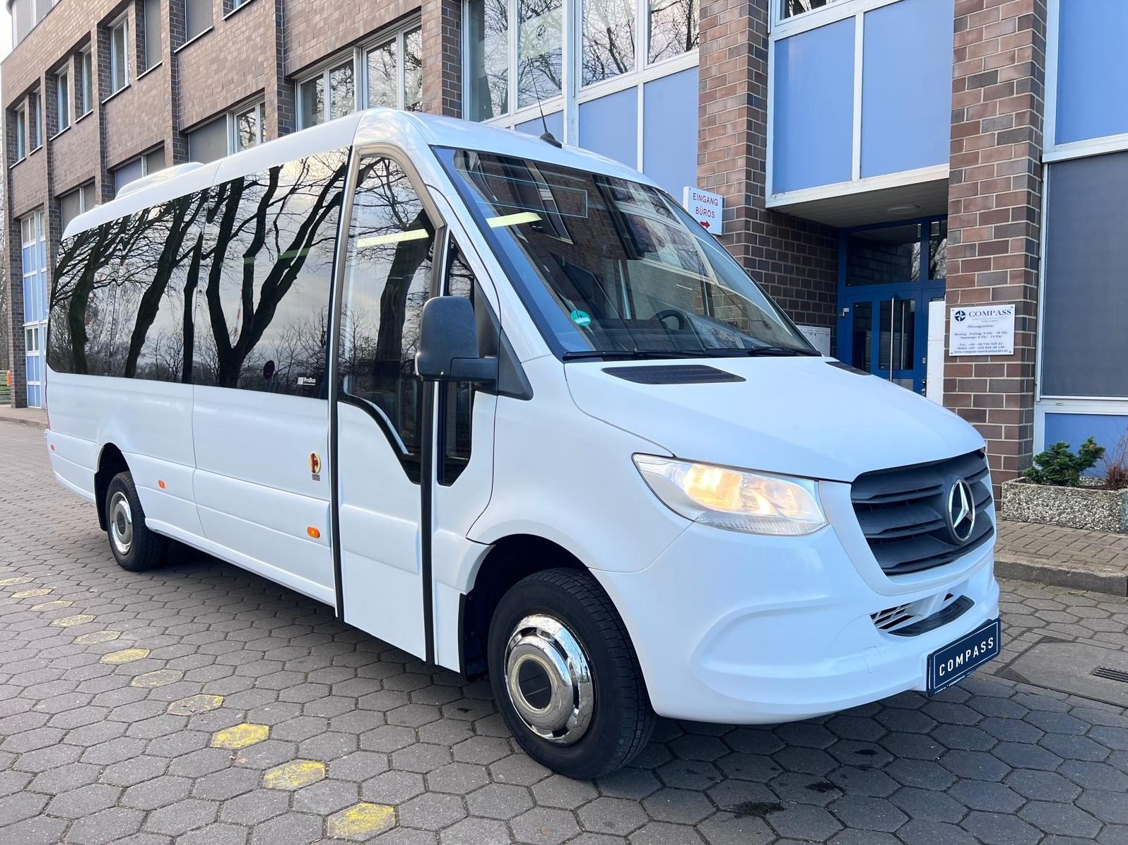 Mercedes-Benz Sprinter minibus in front of the Compass office