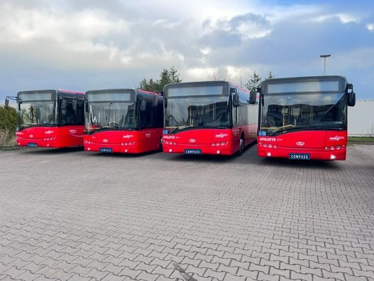 Four red Solaris Urbino city buses
